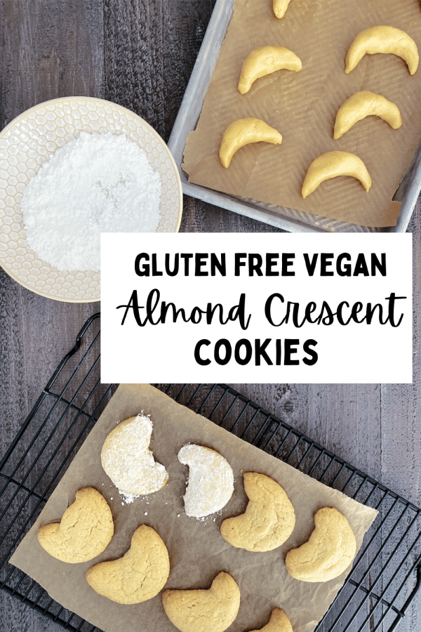 how to make vegan almond crescent cookies: one cookie sheet of raw cookies about to go in the oven, a cooling rack of warm, fresh baked cookies being dipped into powdered sugar