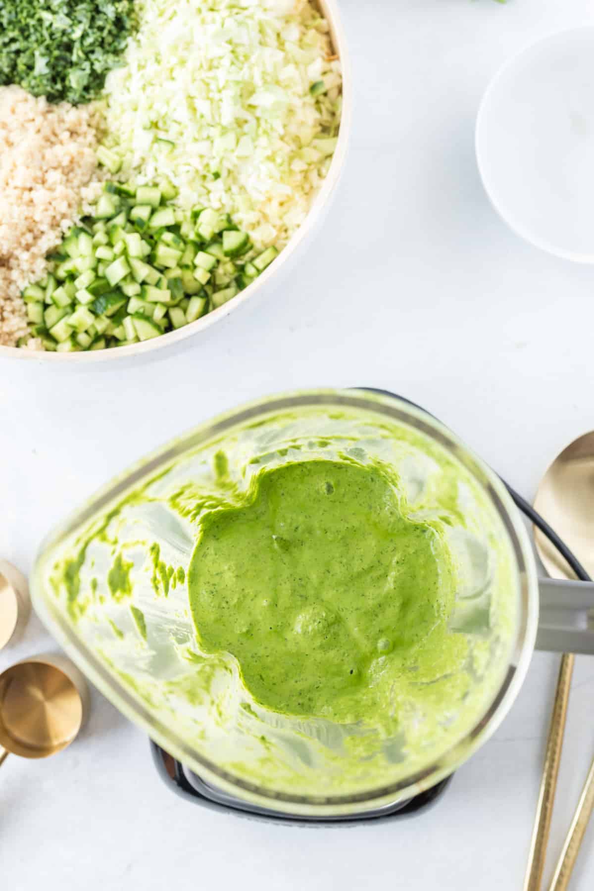 overhead view of a blender jar with green goddess dressing