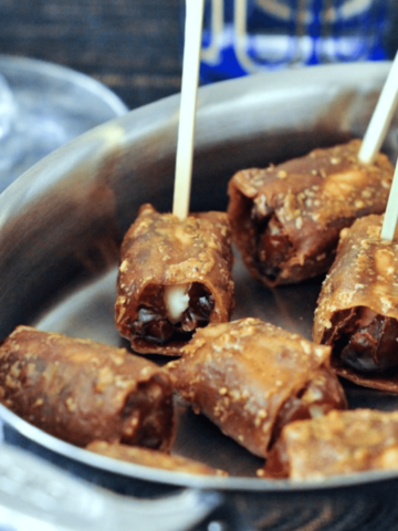 vegan bacon made from rice paper, wrapped around dates and stuck with toothpicks