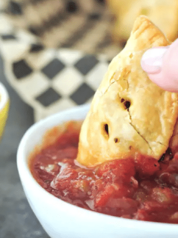 Taco Hand Pie dipped into salsa