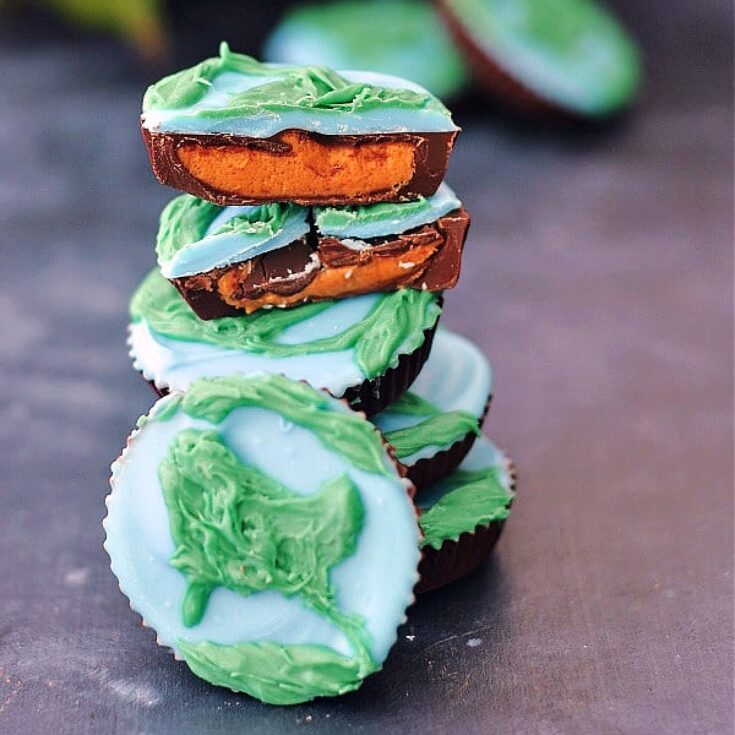 close up stack of peanut butter cups decorated as blue and green earths for Earth Day