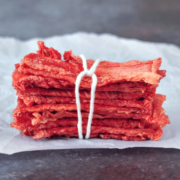 Watermelon candy strips in a stack, tied with twine
