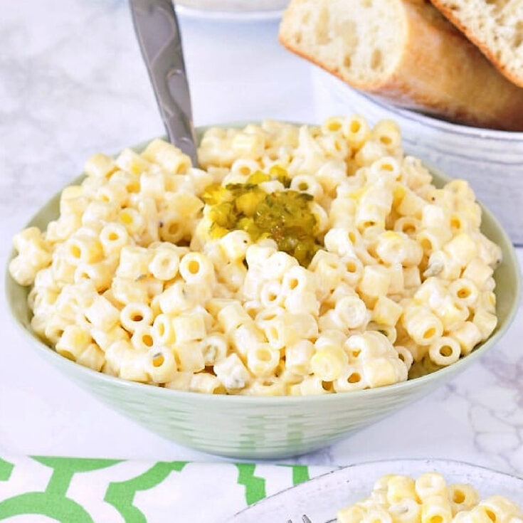 Hawaiian mac salad in a green serving bowl, with a smaller plate of mac salad on the side.