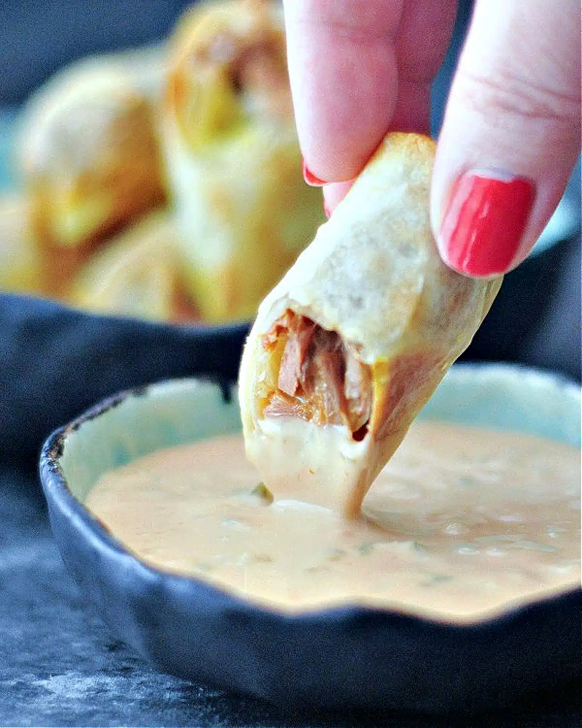 An air fried Reuben flavored egg roll dipped into a bowl of Thousand Island dressing.