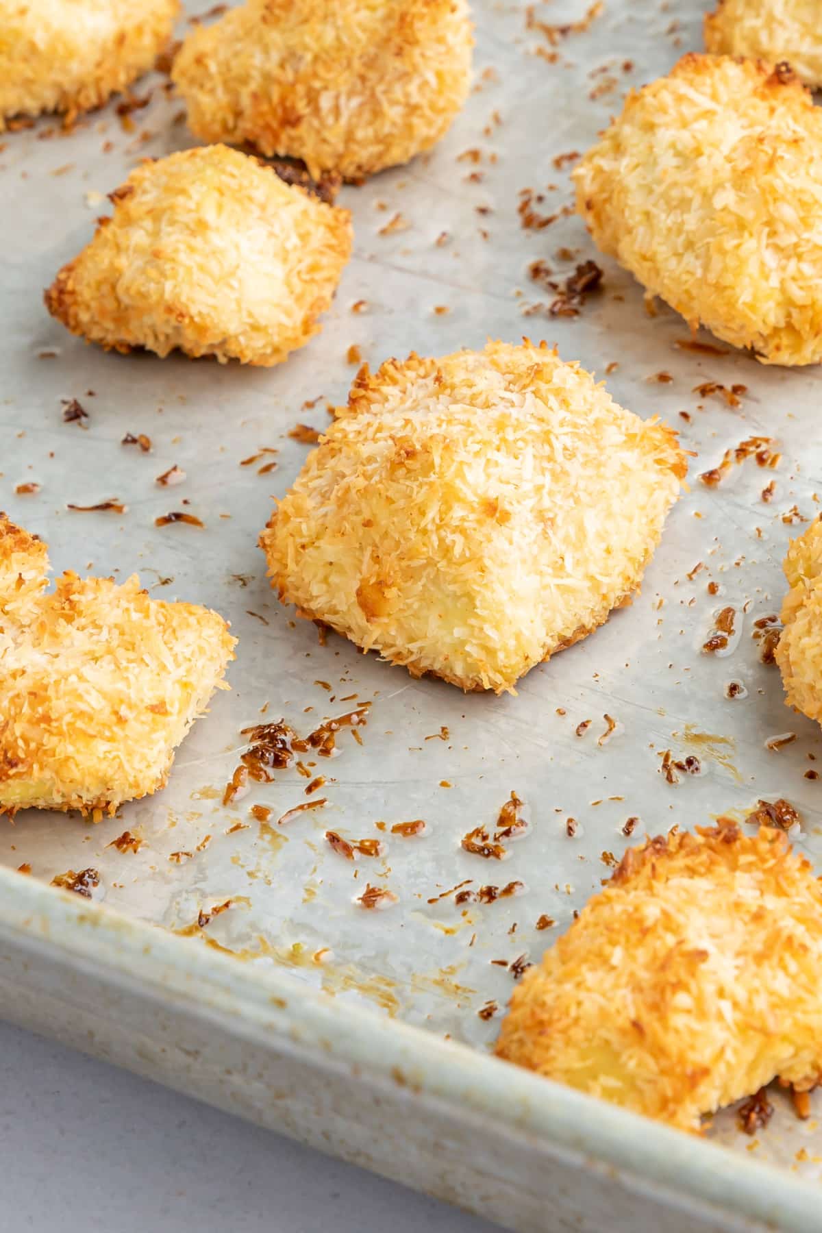 A baking sheet of crispy golden baked coconut tofu pieces.