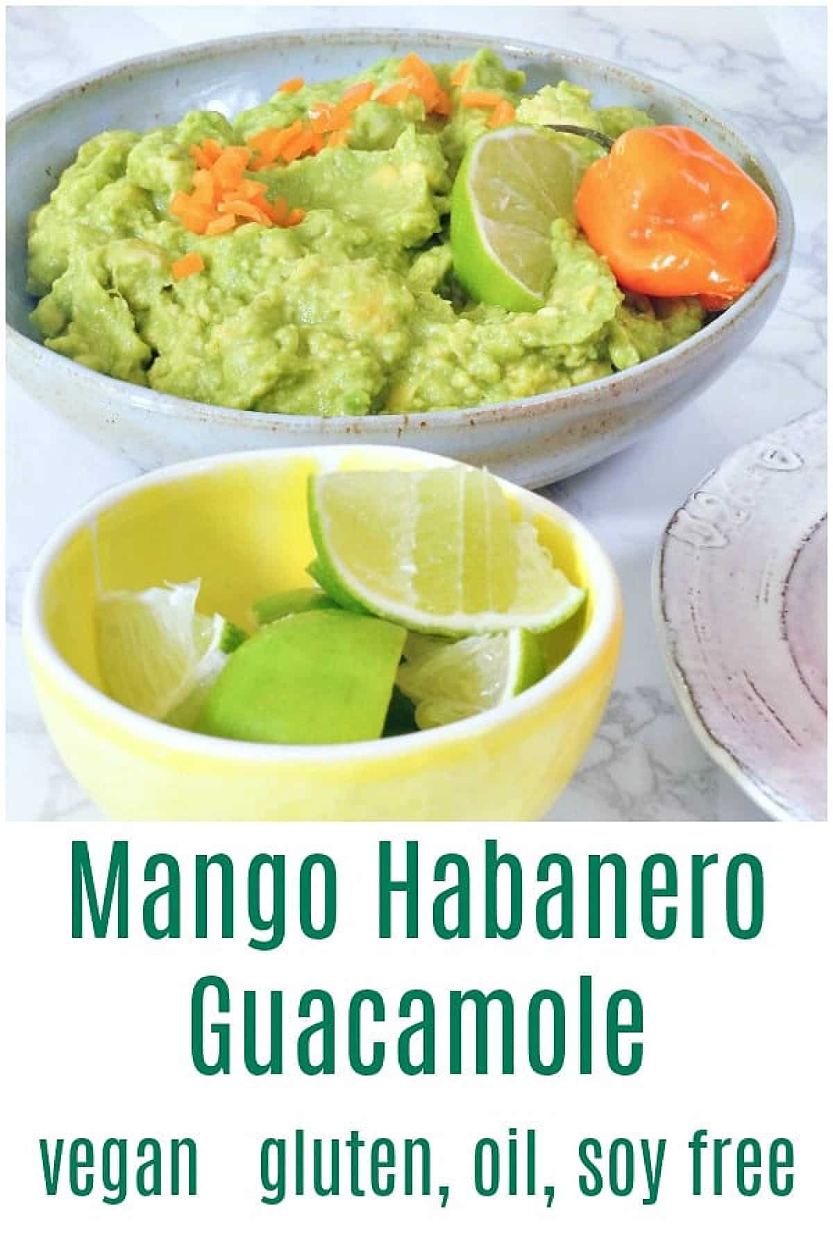 Mango habanero guacamole served in a shallow grey bowl. A smaller bowl of lime wedges on the side.