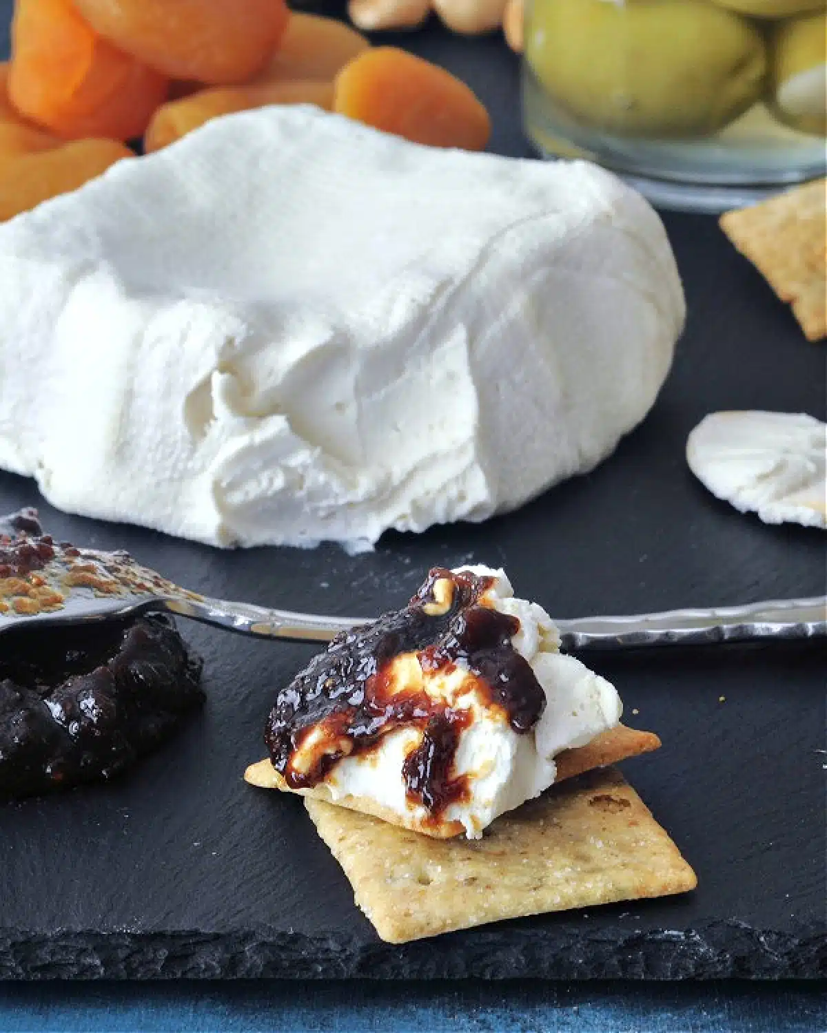 Dairy free cream cheese on a cracker with jam.